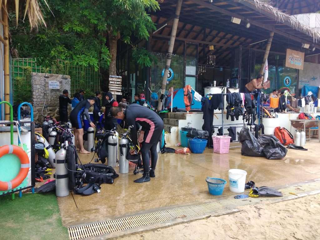 Group of divers on the beach preparing